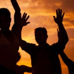 People partying at a beach during sunset