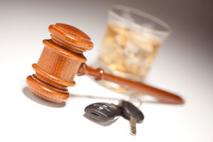 Don't drink and drive concept. Close up of man hand drinking beer and holding car keys. Responsibly and safety driving