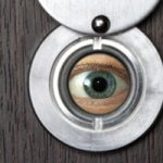 eye looking through peephole